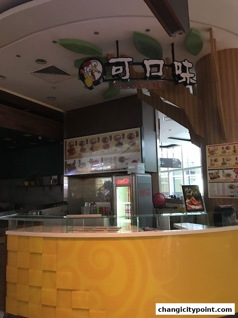 Snackz It! shop front with a bright yellow counter and menu displays.