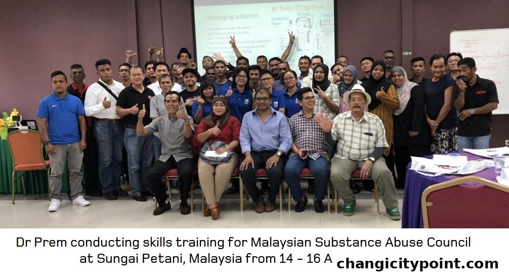 Group photo of people attending a skills training session on challenging addiction.