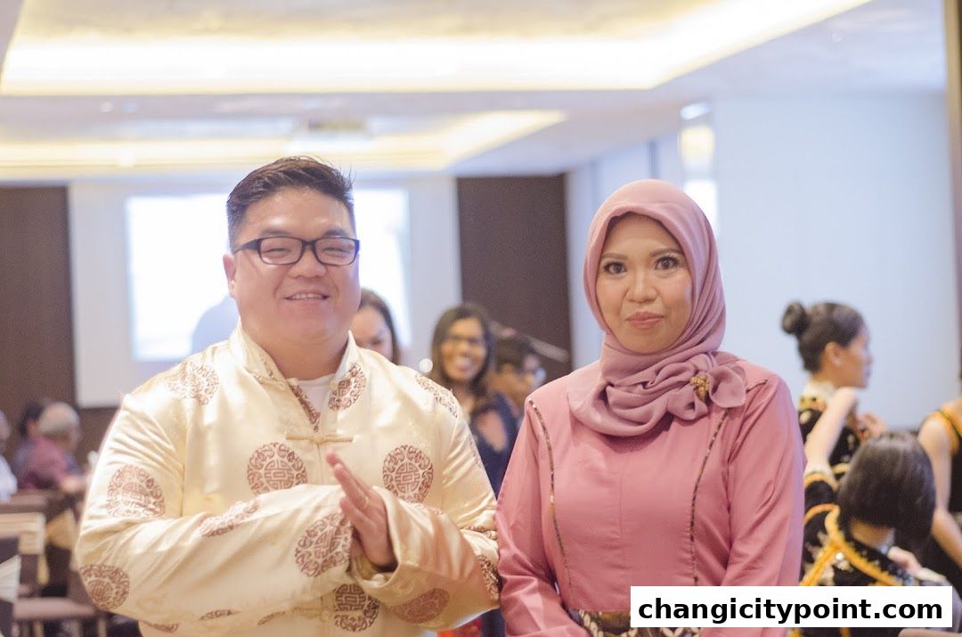 A man and a woman in traditional attire smiling at the camera.