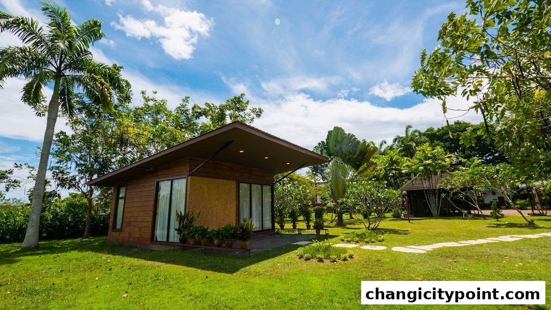 A modern wooden shop with large windows set in a lush green garden.
