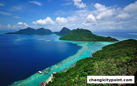 Aerial view of tropical islands with turquoise waters and lush green mountains.