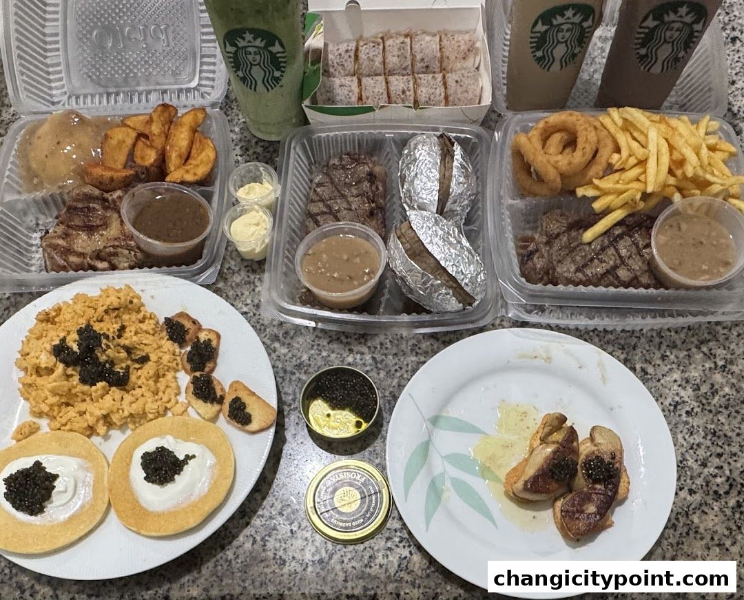 A spread of takeout food including steaks, fries, drinks, and caviar.