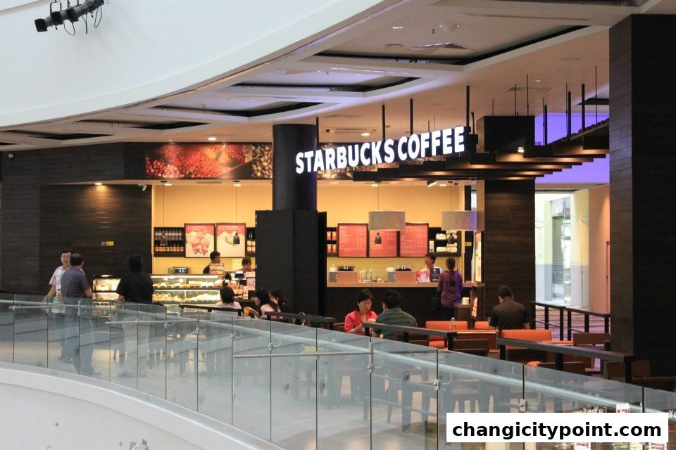 Interior view of a Starbucks coffee shop with customers and staff.