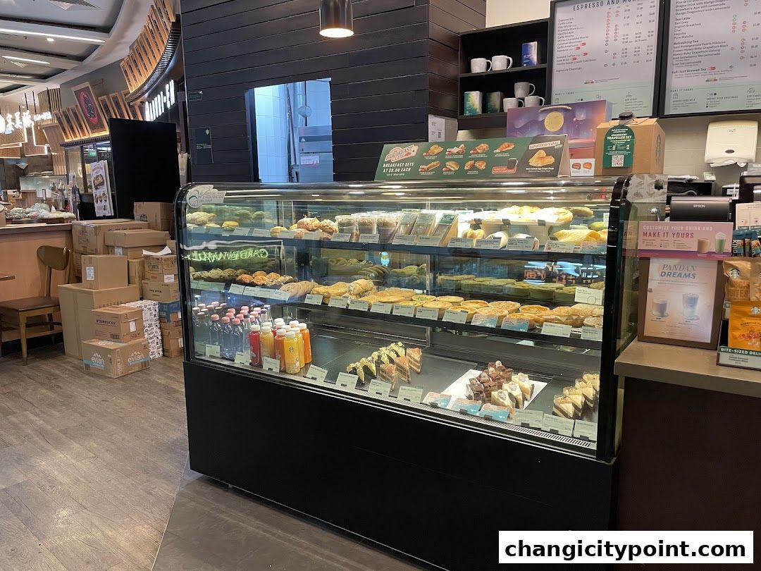 A display case filled with pastries and drinks at a Starbucks.