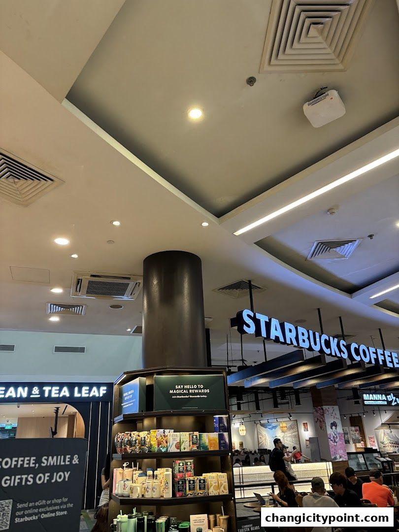 Interior view of a Starbucks coffee shop with merchandise and seating areas.