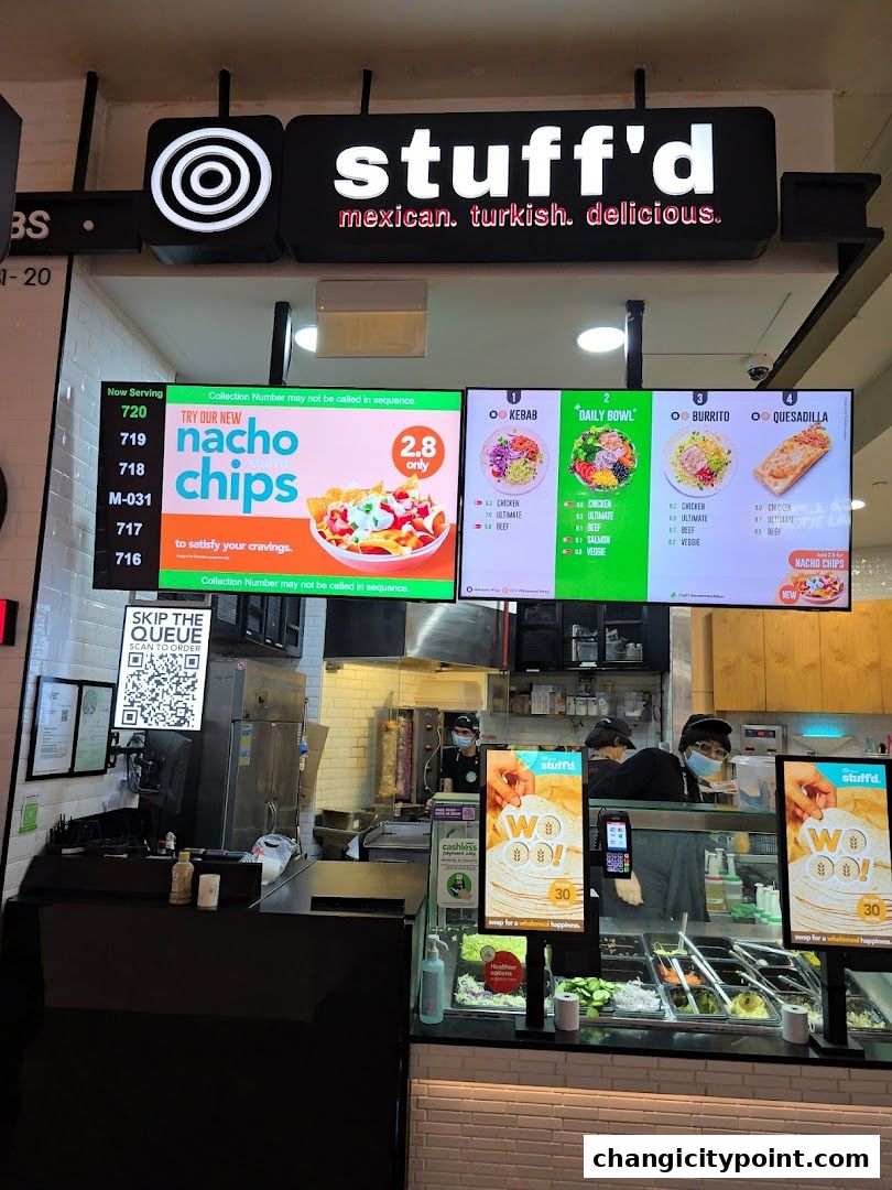 Digital menu boards display food options and prices for Stuff'd restaurant.