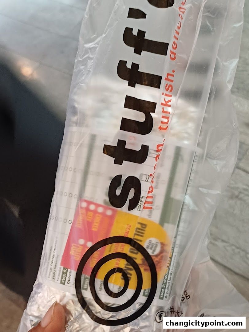 A plastic bag from Stuffd with food items and menu details visible inside.
