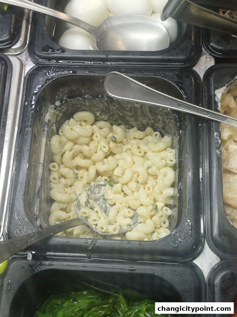 A close-up shot of a deli counter with macaroni salad and hard-boiled eggs.
