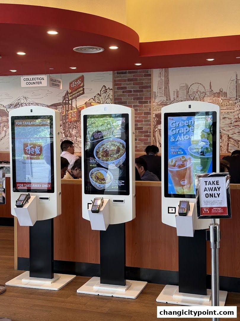 Self-order kiosks display food and drink options at Sukiya Gyudon Curry.