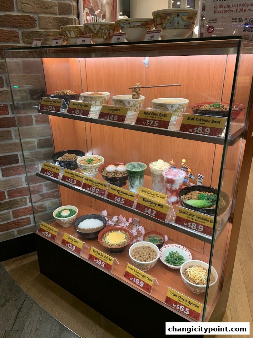 A display case showcasing realistic food models of Japanese rice bowls and drinks.