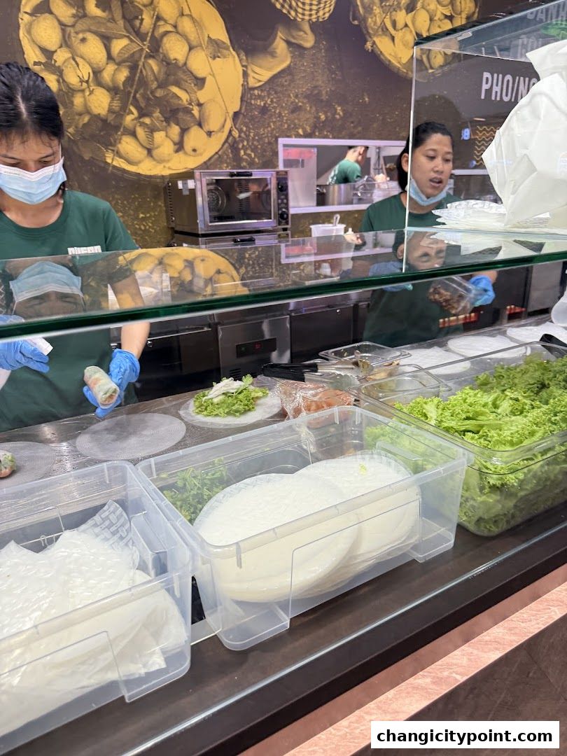 Staff preparing fresh ingredients for Vietnamese spring rolls at Supergreen.