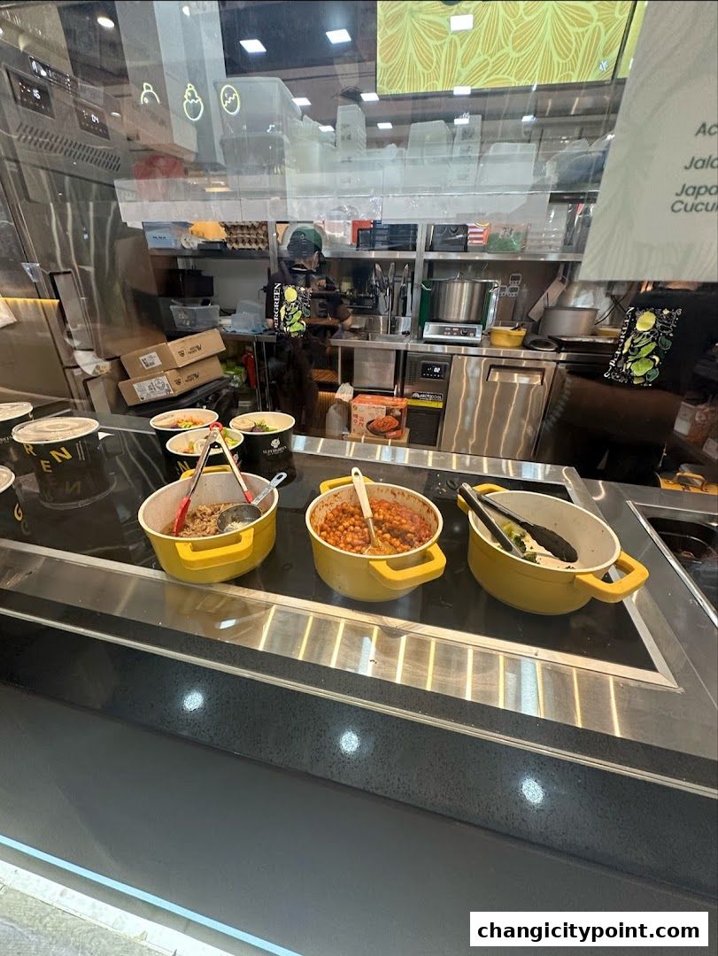 A display of food options at Supergreen, with a staff member visible in the background.
