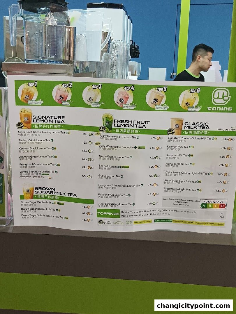 A menu board for Taning with various lemon teas, milk teas, and toppings.