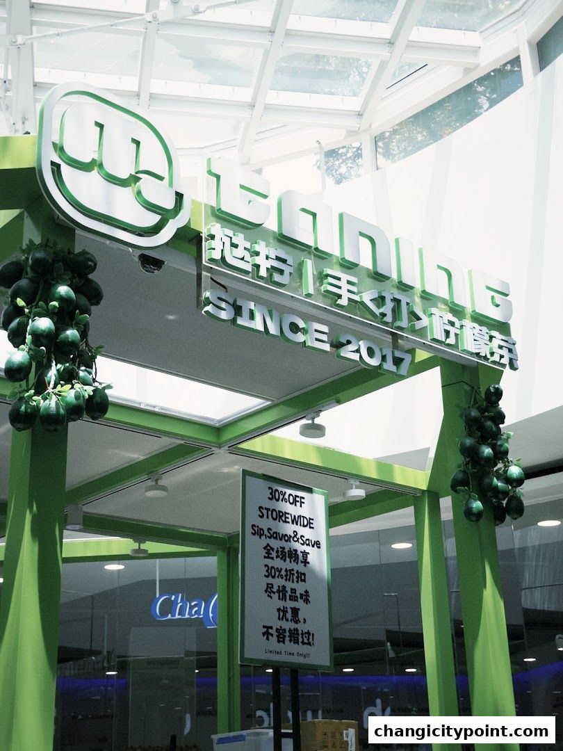 A shop front with a green structure, signage, and a promotional sign.