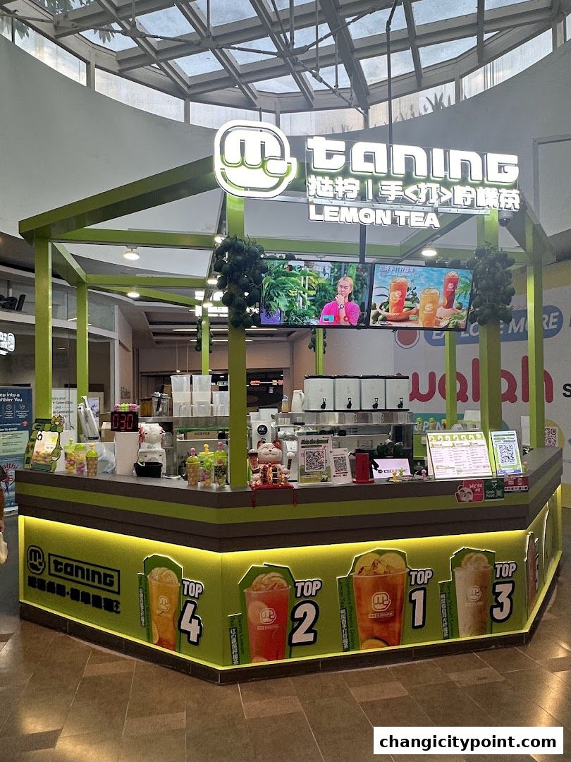 A Taning Lemon Tea stall with colorful drink displays and a menu board.