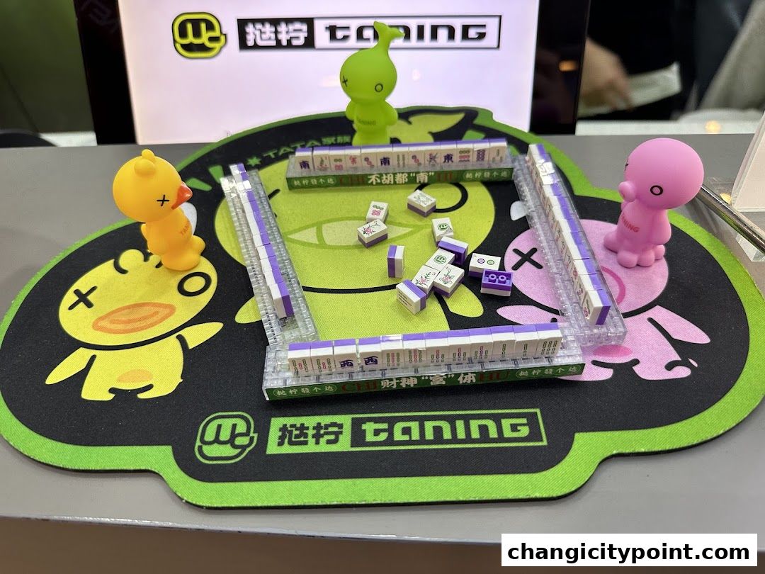 A display featuring mahjong tiles and cute character figurines on a branded mat.