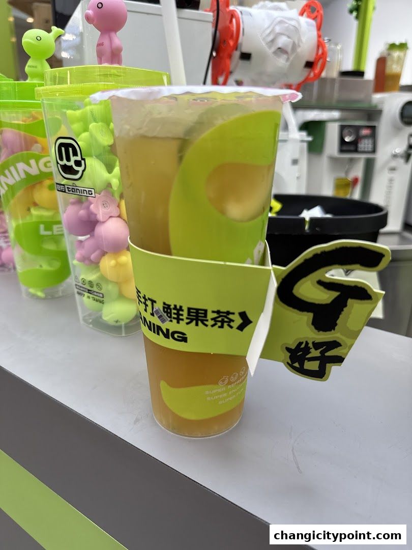 A close-up of a refreshing fruit tea drink with cute animal-shaped toppings in the background.