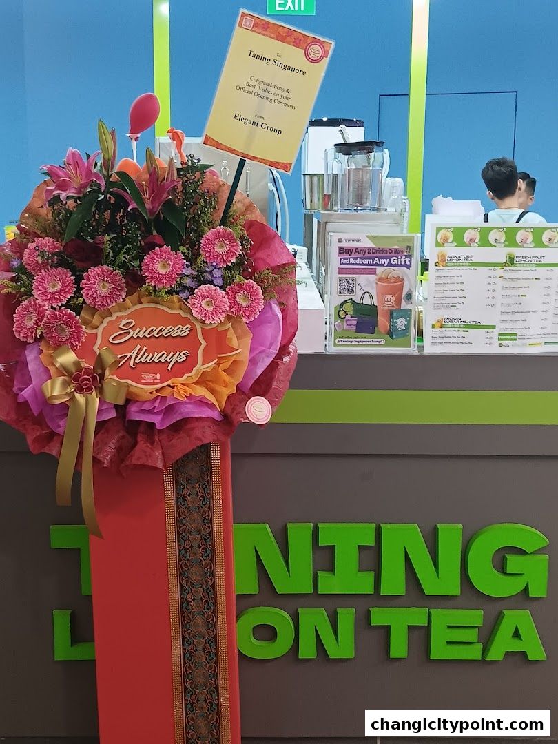 Taning Singapore's official opening ceremony with a floral arrangement and menu display.
