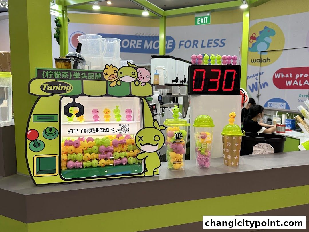 A Taning shop counter with a claw machine, drinks, and a digital timer.
