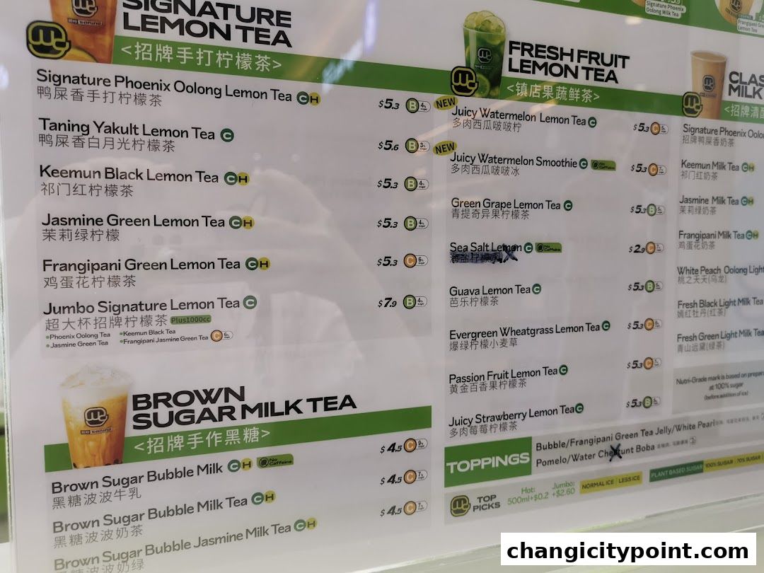 A menu board displaying various lemon teas, milk teas, and toppings with prices.