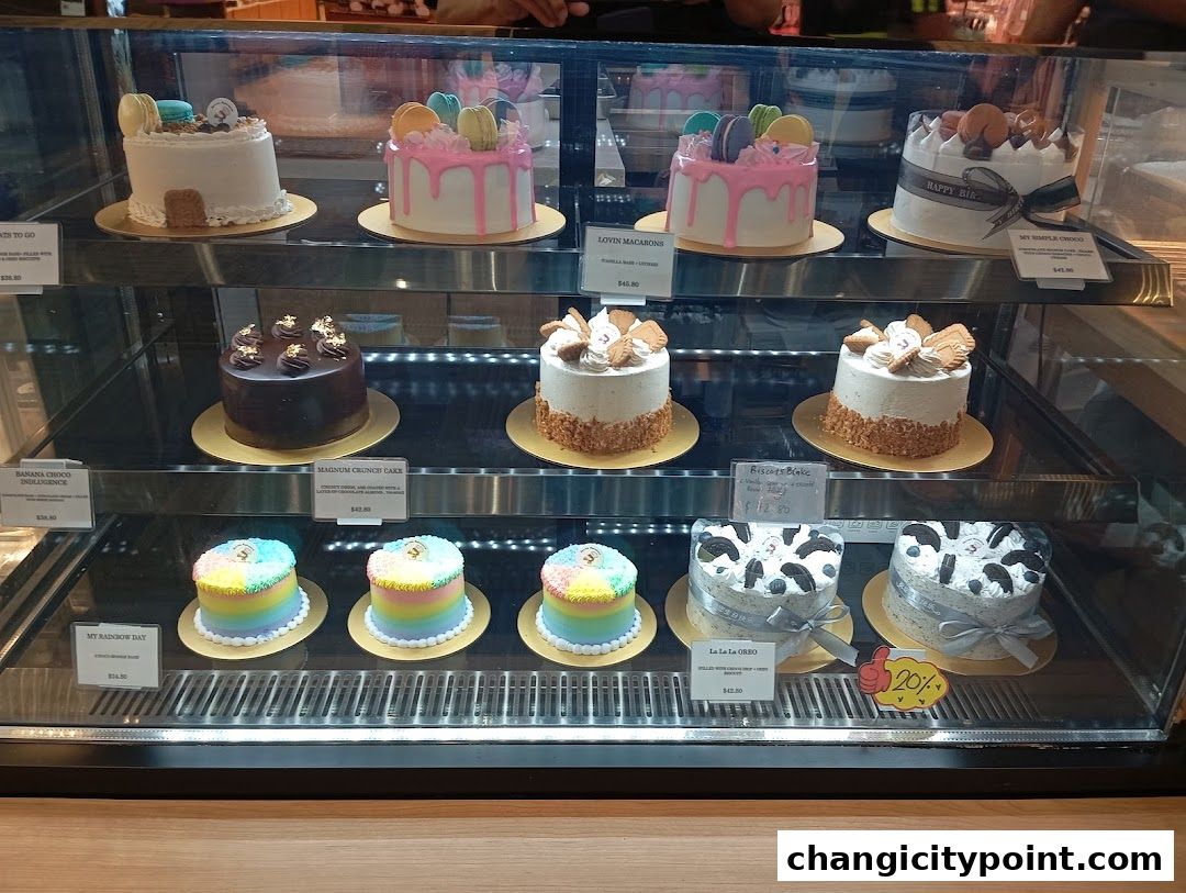 A display case filled with various beautifully decorated cakes and pastries.