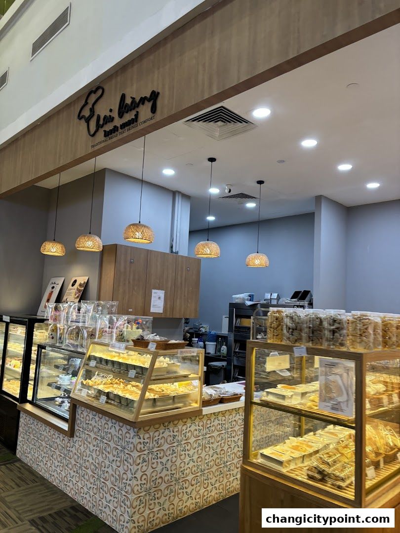 Interior view of Thai Baang Bakery Changi City Point, showcasing display cases filled with baked goods.