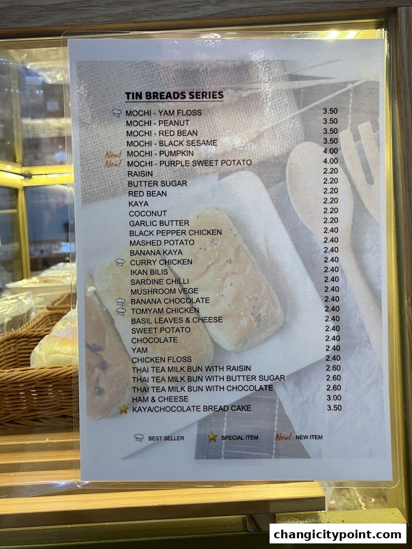 A menu board displays a variety of tin bread series with prices.
