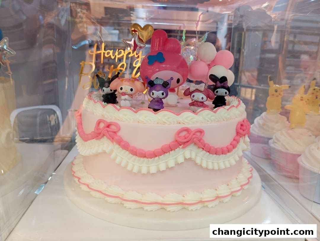 A pink birthday cake decorated with Sanrio characters and a 'Happy Birthday' topper.