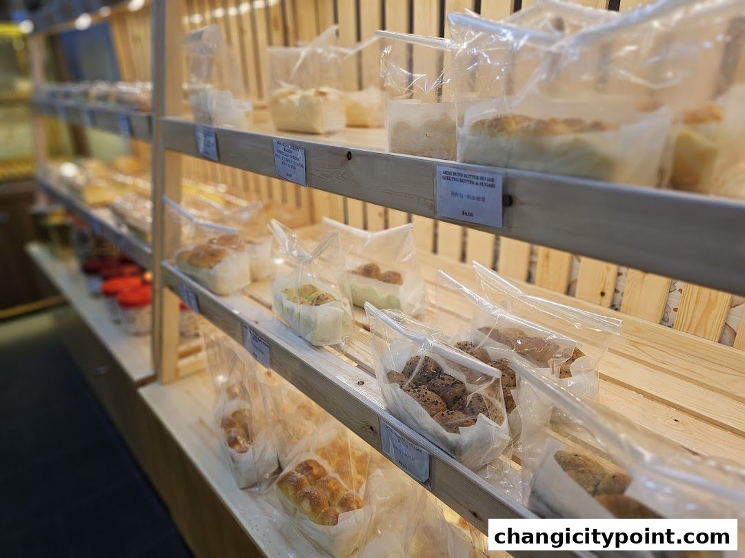 Shelves filled with freshly baked bread and pastries at Thai Baang Bakery.
