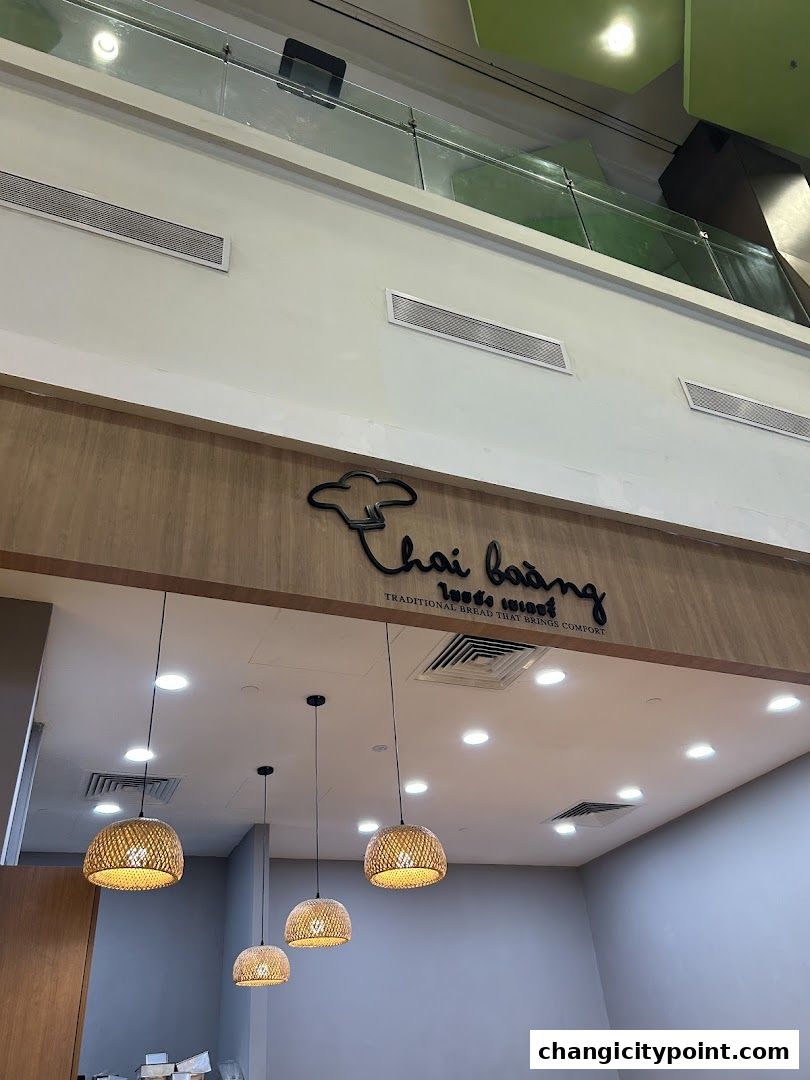 Interior shot of Thai Baang Bakery Changi City Point with decorative lighting.