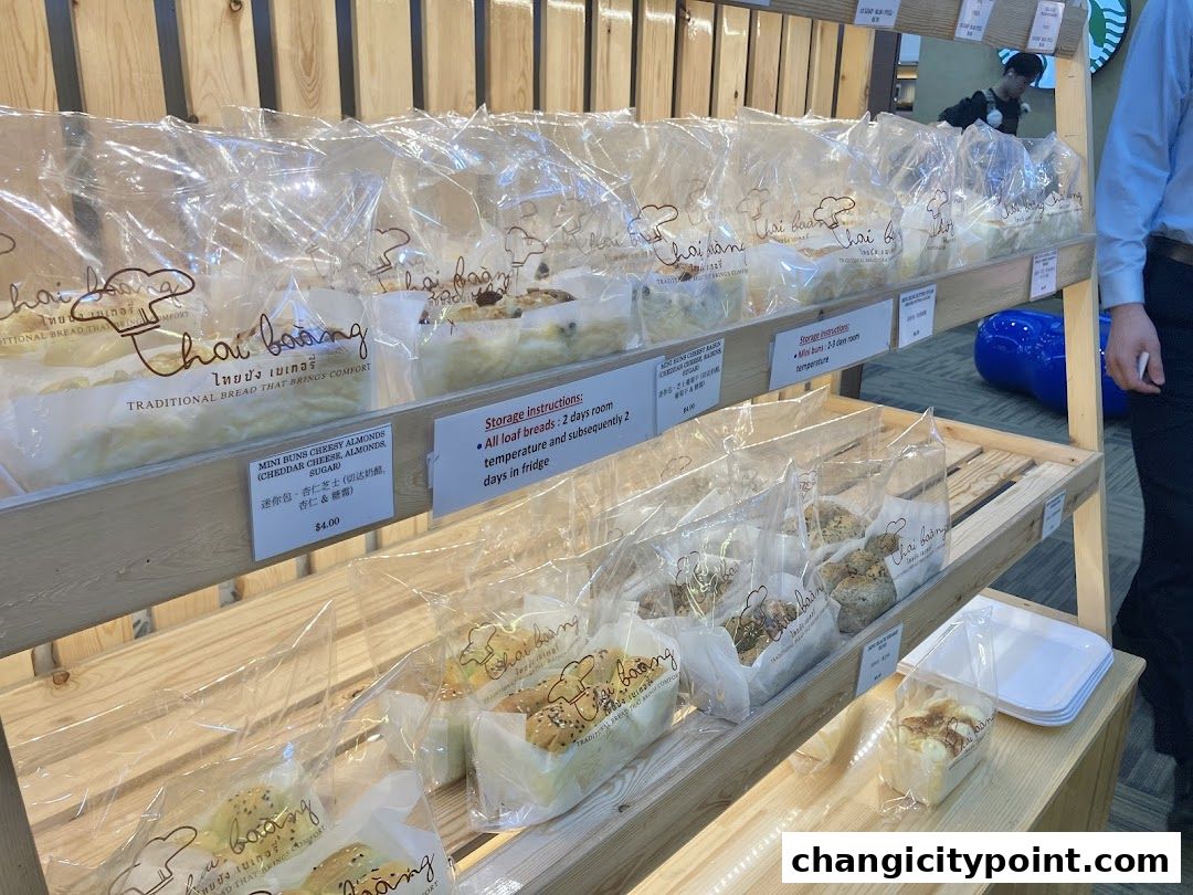 Shelves filled with individually packaged bread and buns from Thai Baang Bakery.