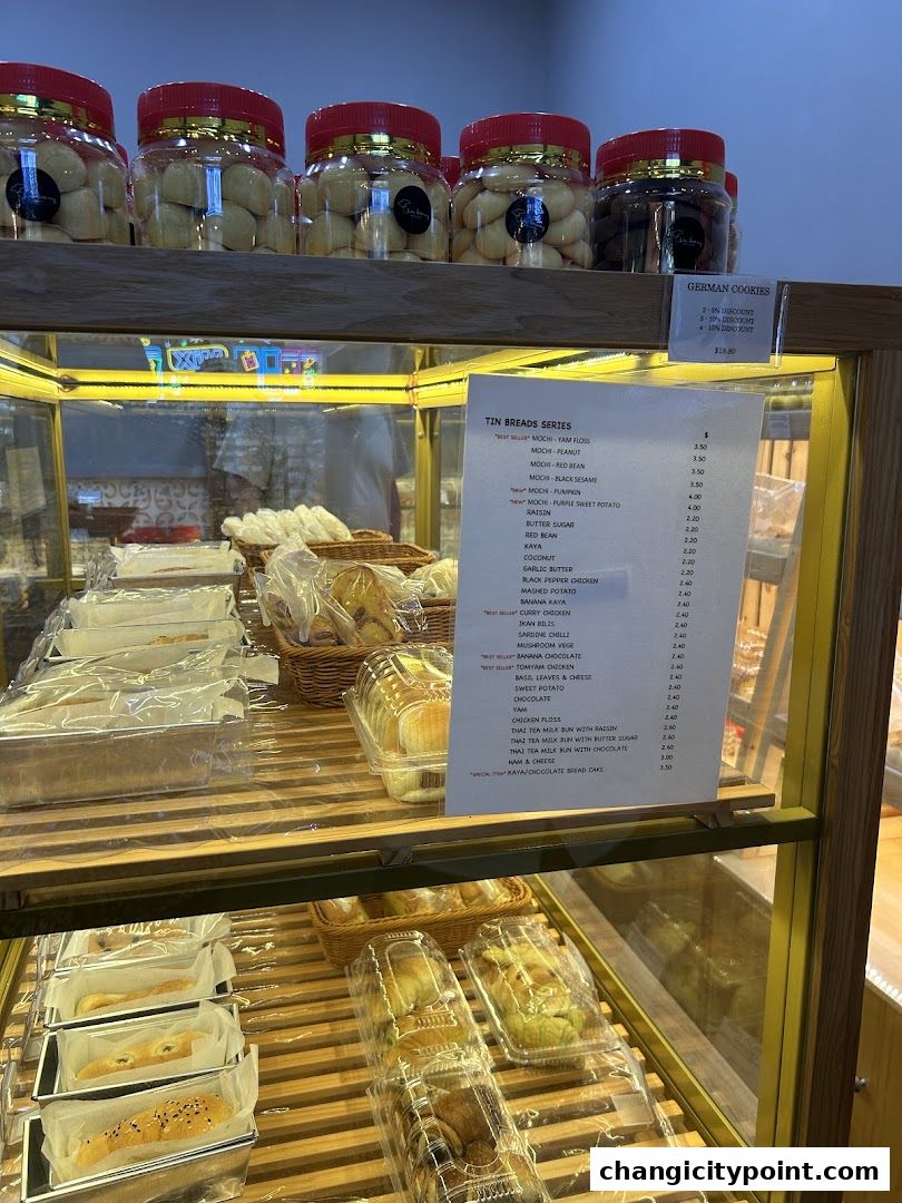 A display of various baked goods and cookies with a price list.