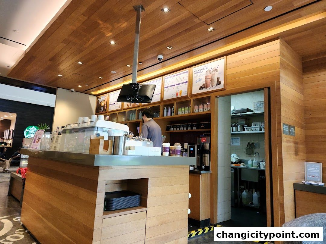 Interior view of The Coffee Bean & Tea Leaf shop with a barista behind the counter.