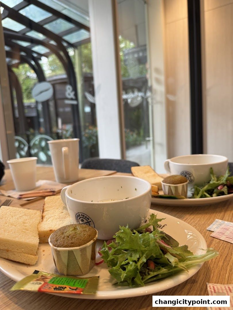A table setting at The Coffee Bean & Tea Leaf with sandwiches, soup, salad, and muffins.