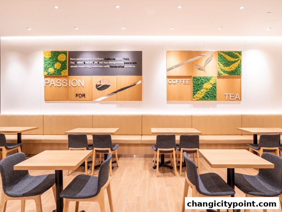 Interior of The Coffee Bean & Tea Leaf with seating, tables, and wall decor.