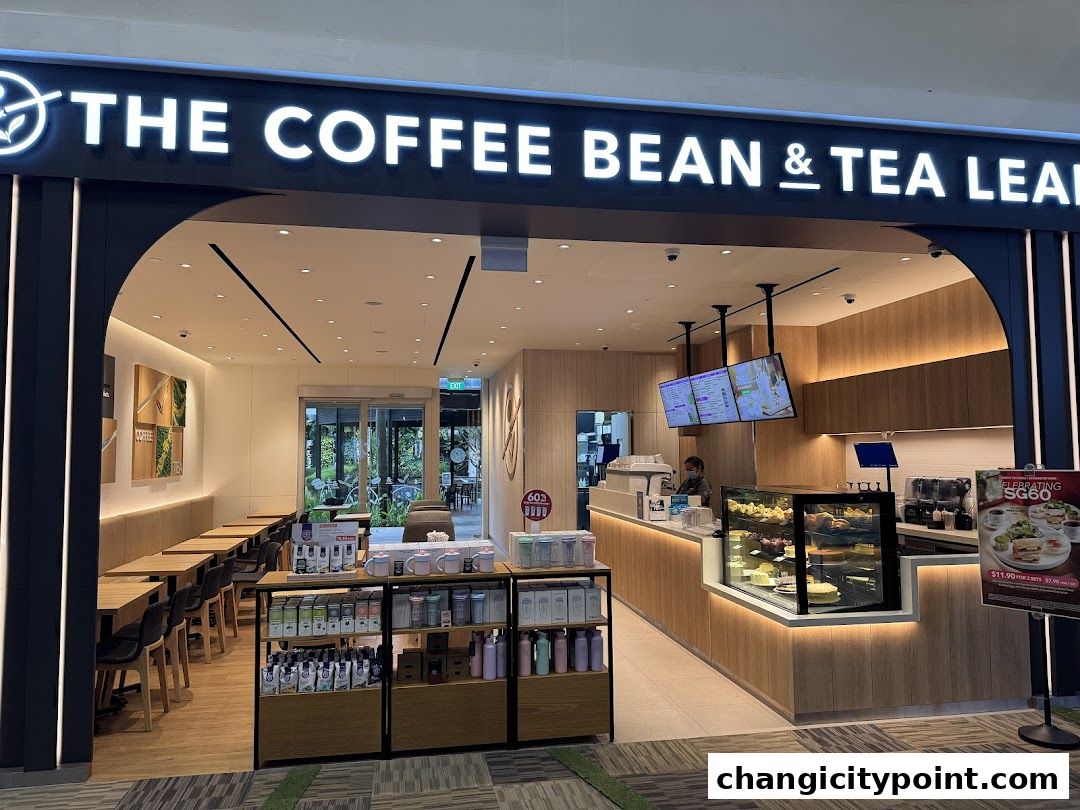 The exterior of The Coffee Bean & Tea Leaf shop with seating and merchandise displays.