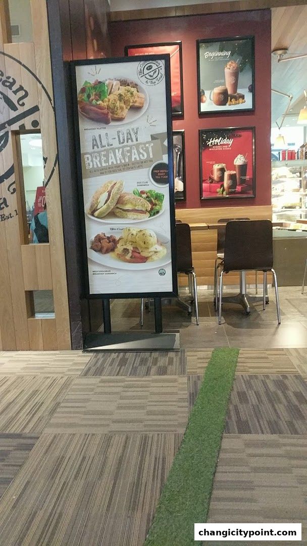 A sign advertising all-day breakfast and holiday drinks at The Coffee Bean & Tea Leaf.
