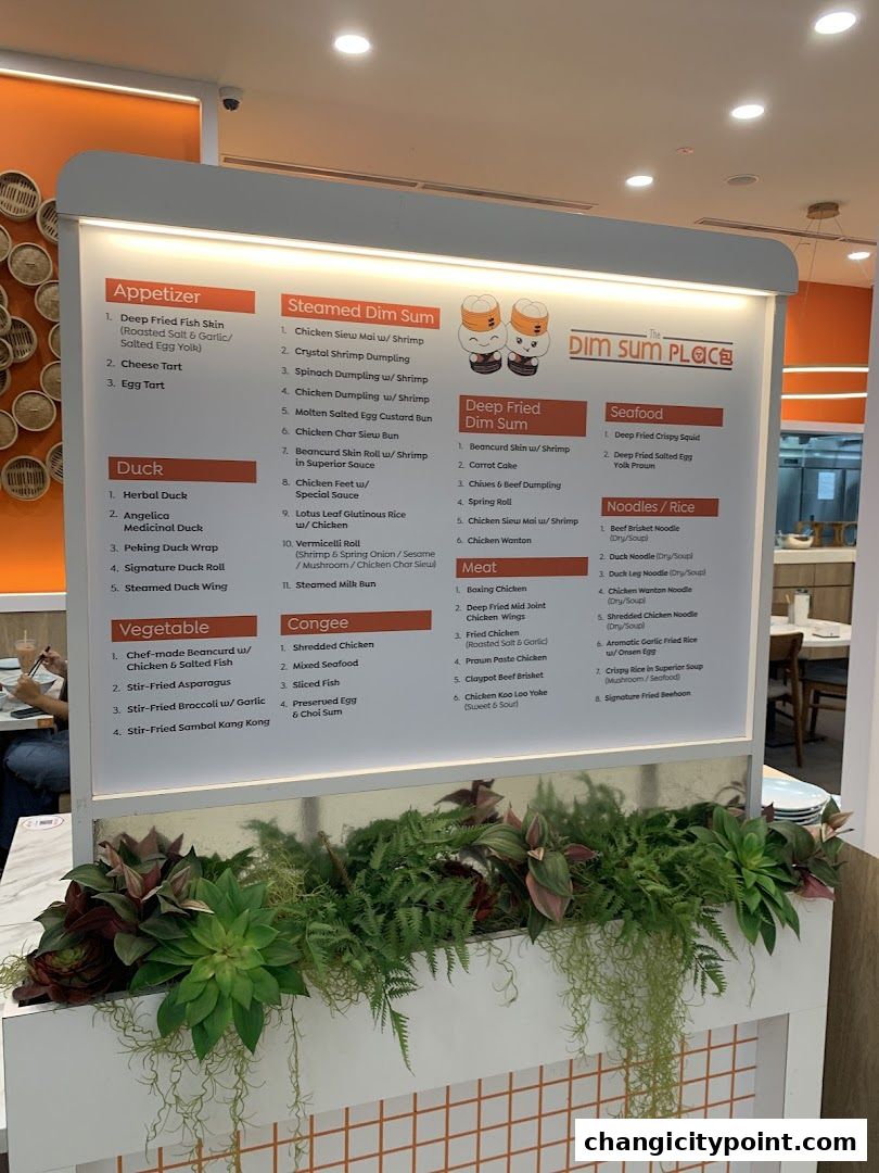 A menu board for The Dim Sum Place, showcasing various dim sum, duck, and seafood dishes.