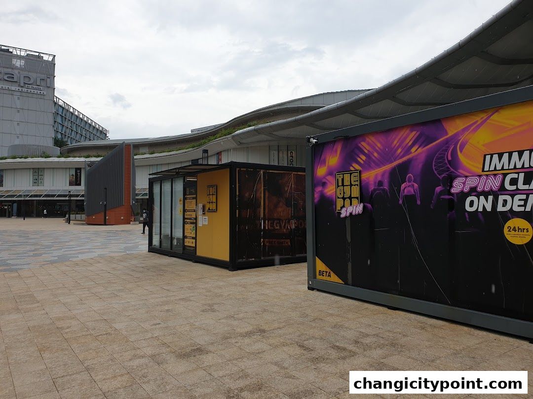 The Gym Pod Spin studio with vibrant graphics and a 24-hour sign.