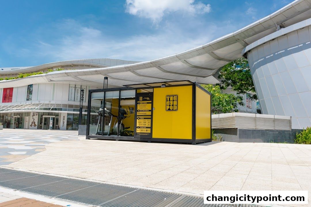 A bright yellow gym pod with treadmills inside, located outdoors.