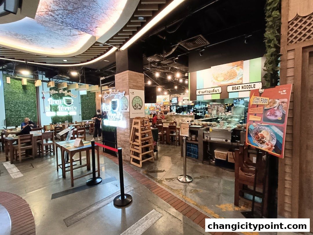 Interior view of The Original Boat Noodle restaurant with seating and food preparation area.