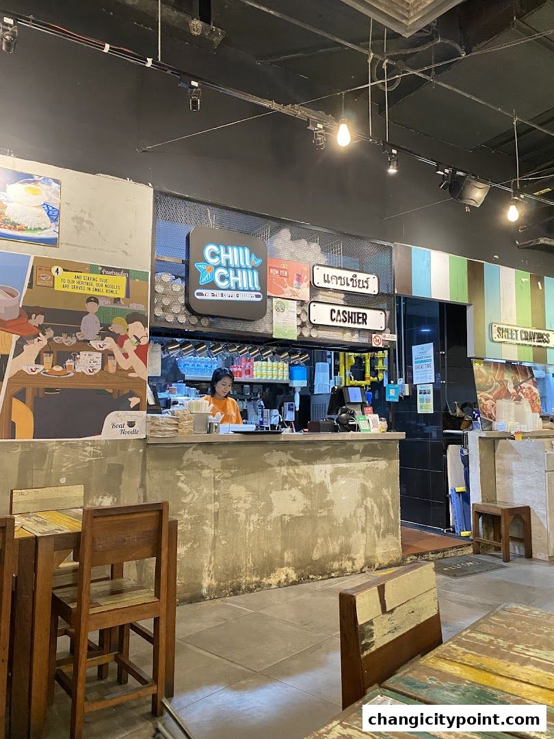 Interior view of The Original Boat Noodle shop with a cashier counter and seating.