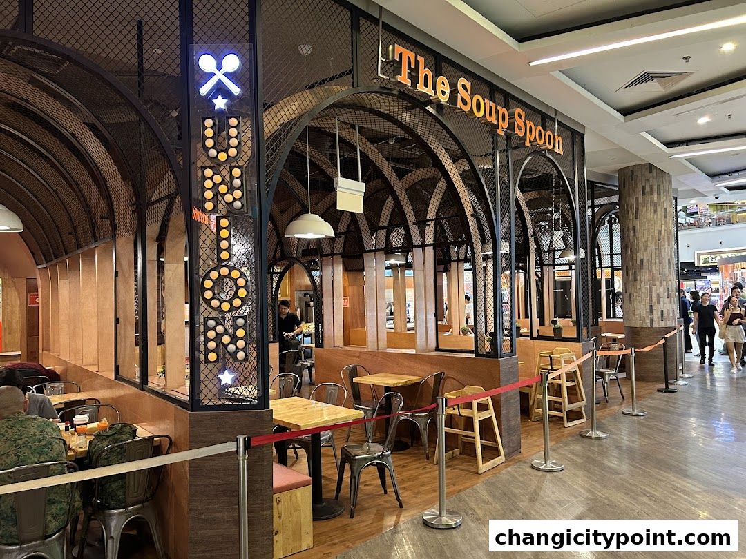 Exterior view of The Soup Spoon Union restaurant with seating and signage.