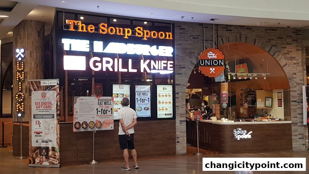 The Soup Spoon Union shop front with illuminated signage and promotional displays.
