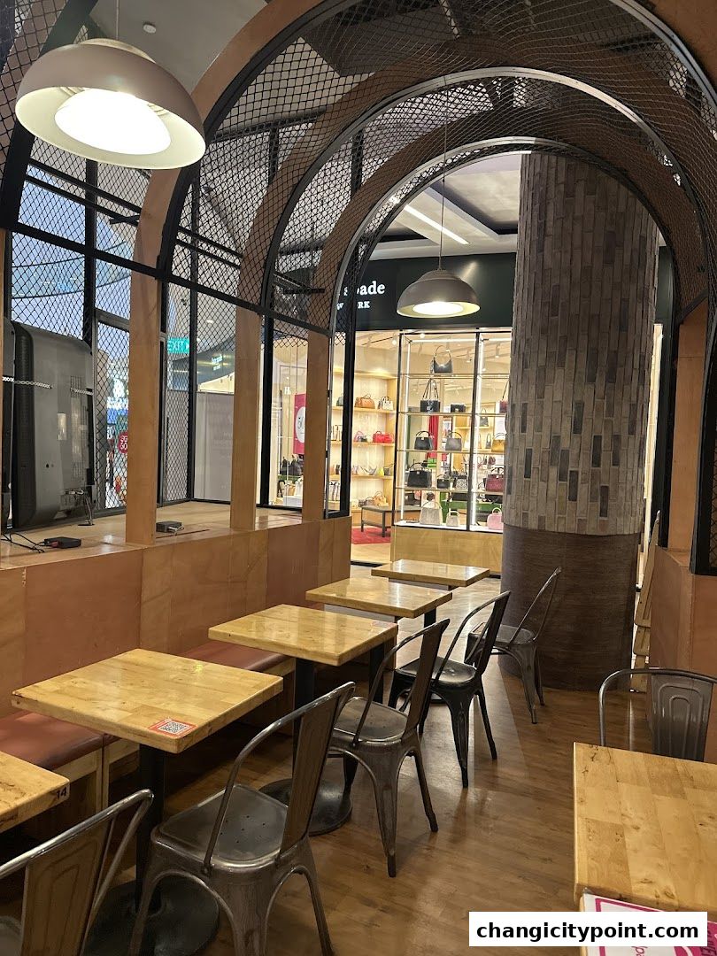 Interior view of The Soup Spoon Union with wooden tables and metal chairs.