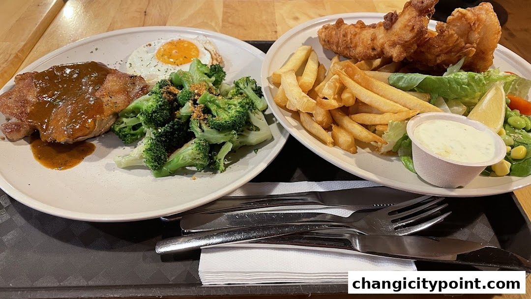 Two plates of food, one with chicken, egg, and broccoli, the other with fish and chips.