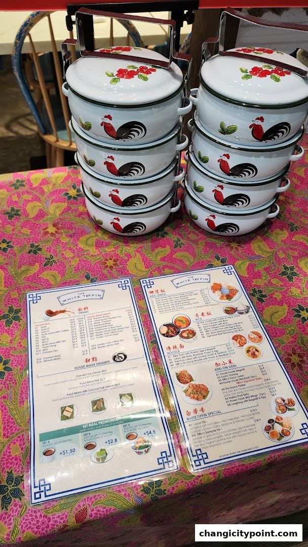 A menu from The White Tiffin featuring traditional dishes and drinks, with decorative tiffin carriers.