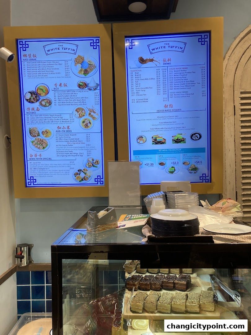 Digital menus displaying food and drink options at The White Tiffin.