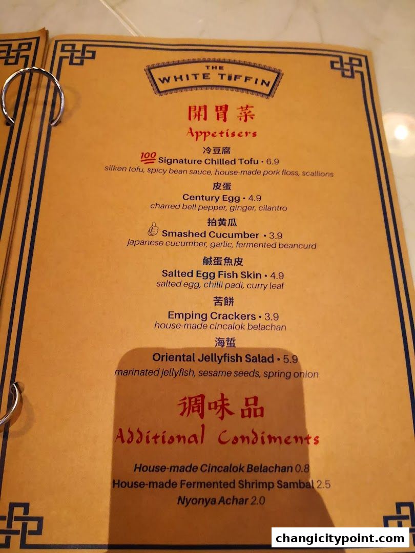 A menu from The White Tiffin featuring appetizers and additional condiments.