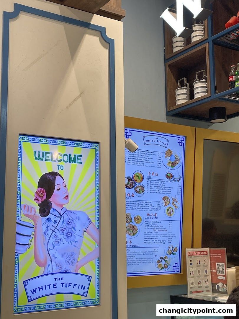 A digital menu board displays food items and prices for The White Tiffin.